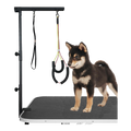 Floof Shop grooming arm clamped to a table, holding a dog