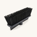 Rubber pet hair broom head on a warm off-white background