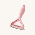 Pink handheld pet hair remover with stainless blade, on a warm off-white background