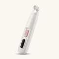 White LED dog nail trimmer on a warm off-white background