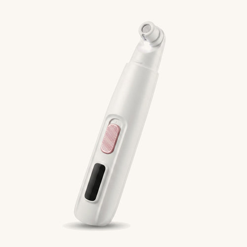 White LED dog nail trimmer on a warm off-white background